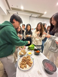 Ryan (Integrated BBA/Year 2) (left), a Vietnamese student host, prepared Vietnamese Spring Rolls.